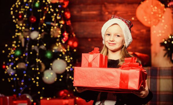 All the gift packs brought by Santa Claus. Happy little girl holding gift boxes on boxing day. Small child getting Christmas or new year gift. Adorable kid carrying beautifully wrapped gift boxes - Фото, зображення