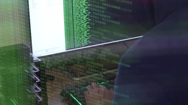 A hacker man writes the green code for an attack. Program a virus with your computer - Footage, Video