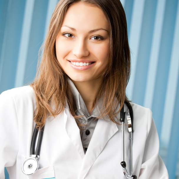 Cheerful female doctor at office - Foto, Bild