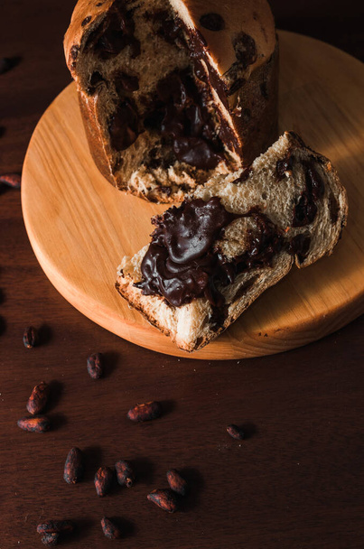 chocolate panettone isolated on dark wooden background,  space for text. - Photo, Image
