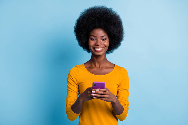 Photo portrait of beautiful cheerful black skinned girl using social media isolated on vivid blue color background - Zdjęcie, obraz