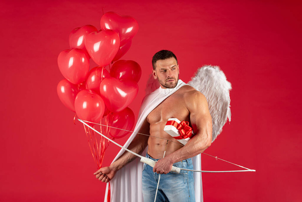 Sexy man on valentines day. Symbol of love. Guy in angel costume. Cupid with bow. February 14. Handsome angel man with angel wings. Great present for girlfriend. Angelic naked young guy. - Foto, Bild