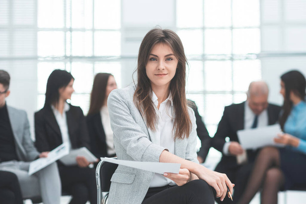 young business woman against the background of her colleagues. - Photo, image