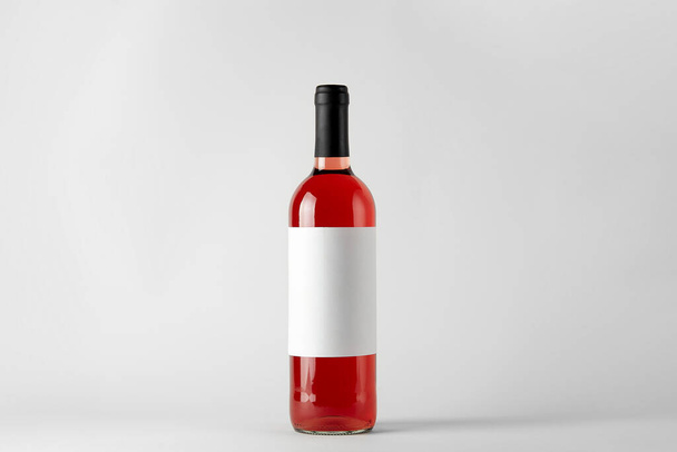Red wine bottle with rose wine isolated on white - Foto, Imagem