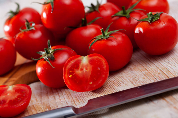 Whole and halved tomatoes - Фото, зображення