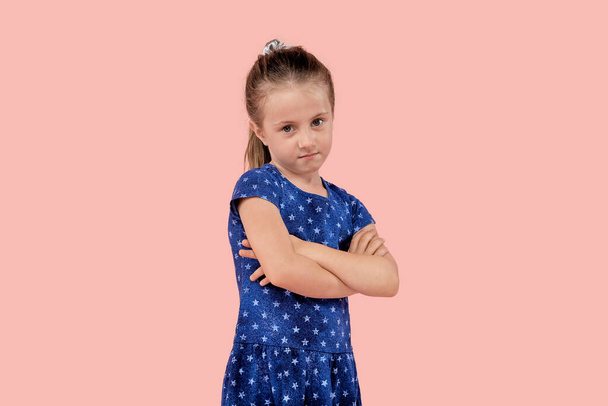 A angry girl is upset and looks angrily at the camera in a blue dress. - Fotoğraf, Görsel