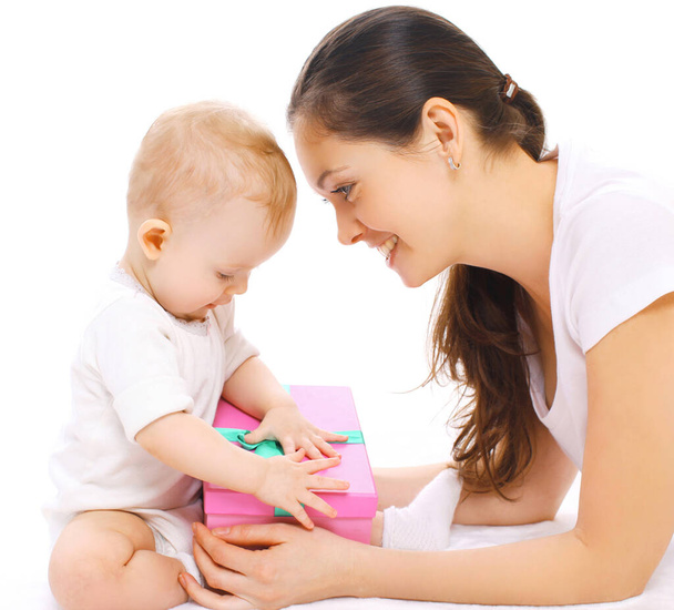 Ritratto di allegra madre sorridente e bambino che gioca con i giocattoli su uno sfondo bianco - Foto, immagini