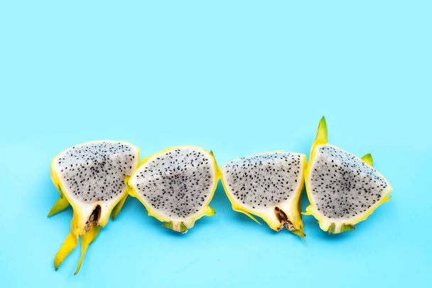 Yellow pitahaya or dragon fruit on blue background.  Top view - Фото, зображення