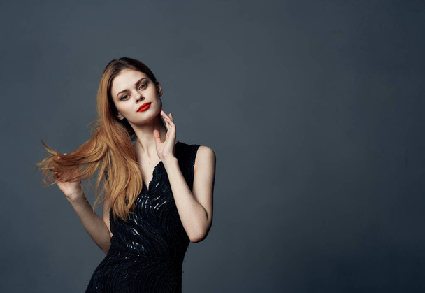 Beautiful woman in black dress red hair gray background Copy Space Model - Foto, Imagen
