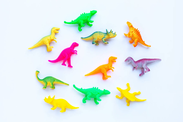 Plastic dinosaur toys on white background. Top view - Photo, Image