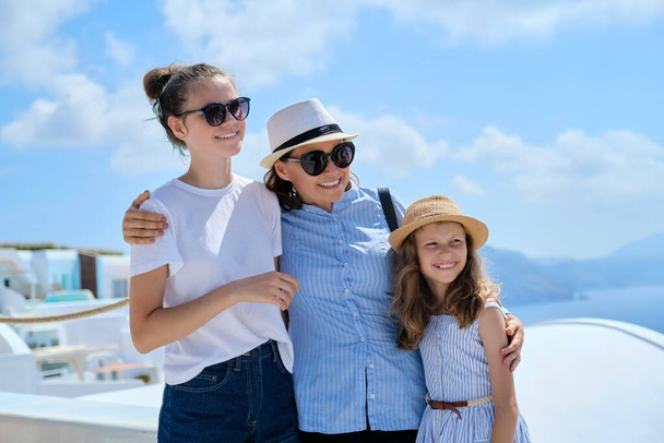 Tourism, travel, Greece, Santorini. Happy travelers mom and daughters - Foto, afbeelding