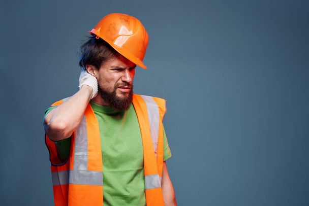 worker man in construction uniform professional lifestyle blue background - Fotó, kép