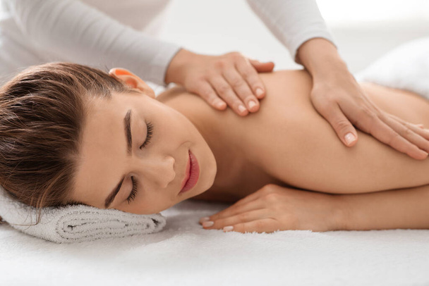 Closeup of beautiful woman enjoying back massage - Фото, изображение