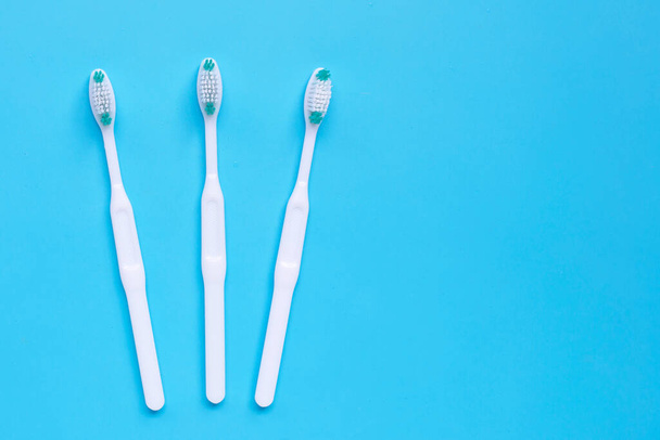 Toothbrushes on blue background. Top view - 写真・画像