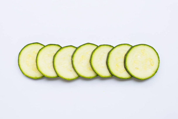 Zucchini slices on white background. Copy space - Photo, Image