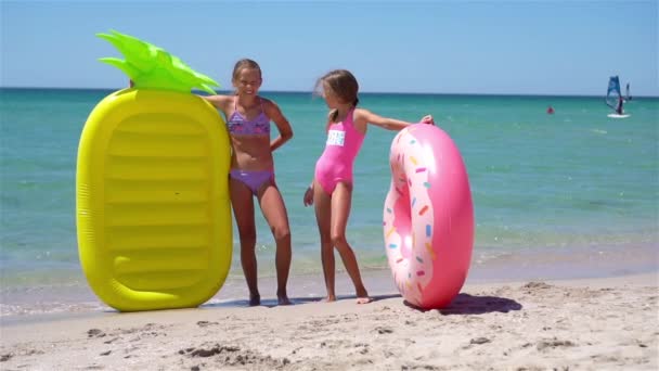 Little girls having fun at tropical beach during summer vacation playing together - Footage, Video