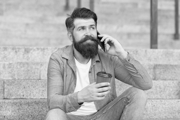 Lets communicate through call. Hipster drink coffee talking on smartphone outdoors. Phone conversation and communication. Mobile communication. Business communication. Using communication technology - Fotografie, Obrázek