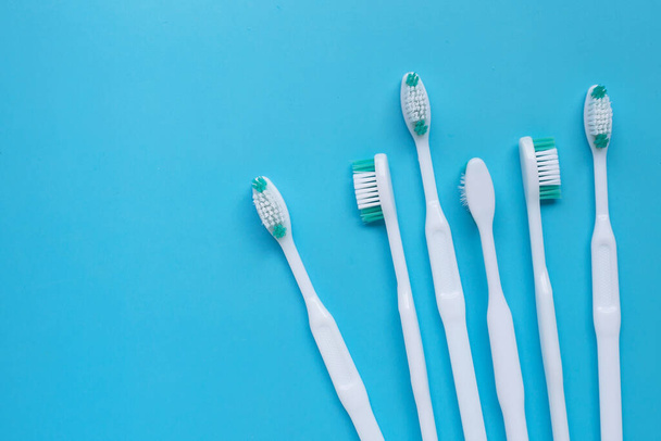 Toothbrushes on blue background. Top view - Photo, Image