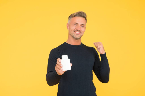 Cologne that will boost your confidence. Happy man present deodorant gesturing with confidence. Perfume shop. Mens grooming. Aftershave balm. After shave lotion. Make your scent a priority - Zdjęcie, obraz