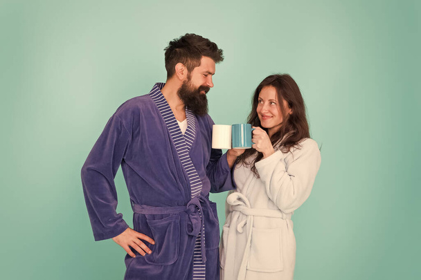 Together more tasty. Coffee is our tradition. Man and woman happy together. Family traditions. Couple in cozy bathrobes enjoy lazy weekend. Drinking coffee. Brewing coffee at home. Hot drink - Photo, Image