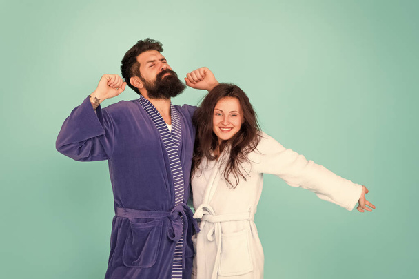 Feeling good. Couple in love enjoy relax. Happy morning. Vacation starting here. Sleepy man and woman happy together. Family traditions. Couple in cozy bathrobes enjoy lazy weekend. Spa and relax - Фото, изображение
