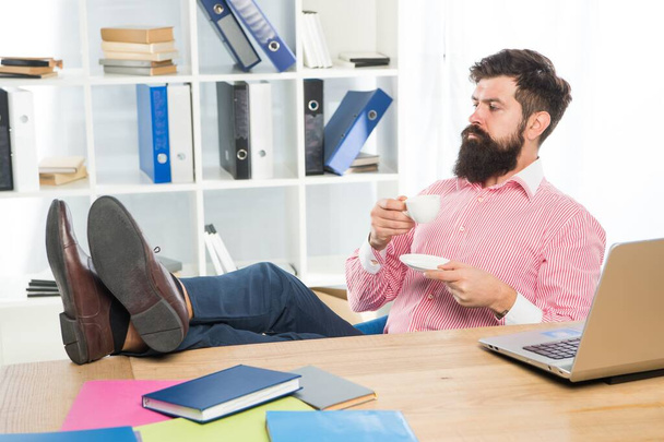 Bearded man enjoy drinking cup of tea or coffee at office desk, pleasure - 写真・画像