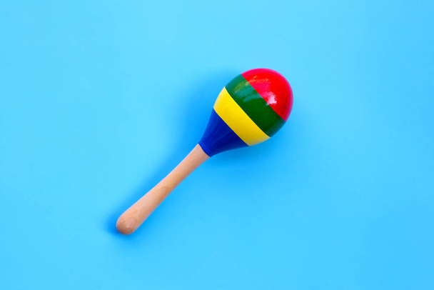 Wooden rattle on blue background. - Foto, immagini