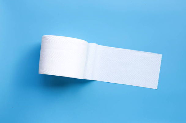 Toilet paper on blue background. Copy space - Фото, изображение