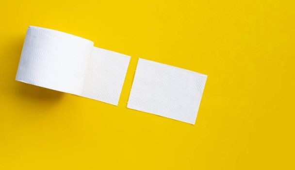 Toilet paper on yellow background. Copy space - Zdjęcie, obraz