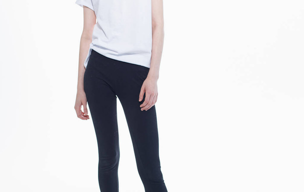 Black leggings white t-shirt woman light background gestures with hands - Fotografie, Obrázek