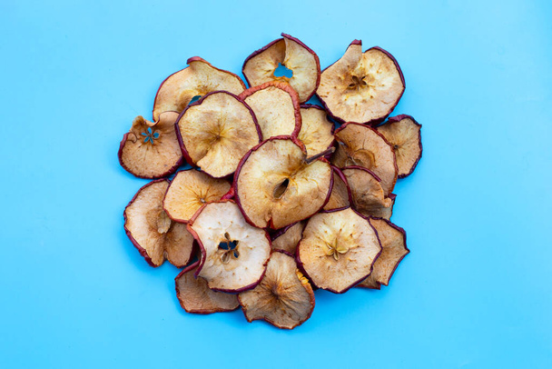 Mavi arka planda kurumuş elma dilimleri - Fotoğraf, Görsel