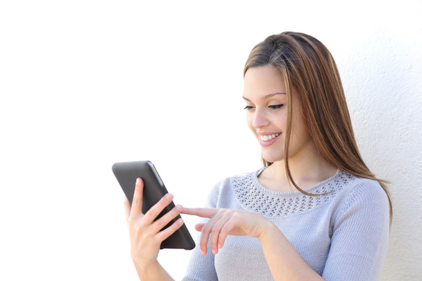 Happy beauty woman texting on a tablet - Фото, изображение