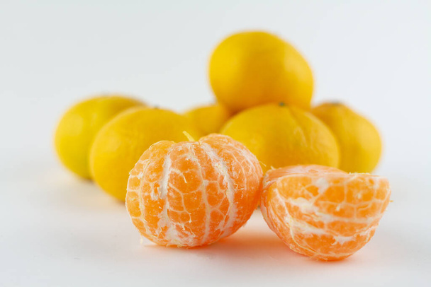 a beautiful ripe peeled tangerine on a white background - Valokuva, kuva