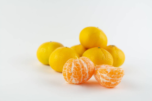a beautiful ripe peeled tangerine on a white background - Fotoğraf, Görsel