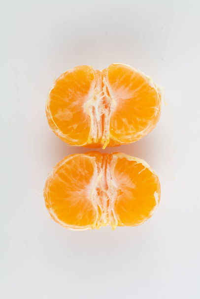 a beautiful ripe peeled tangerine on a white background - Photo, image