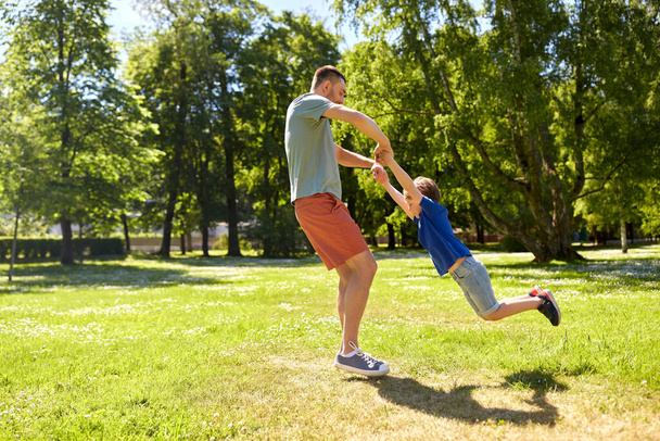 happy father with son playing in summer park - 写真・画像