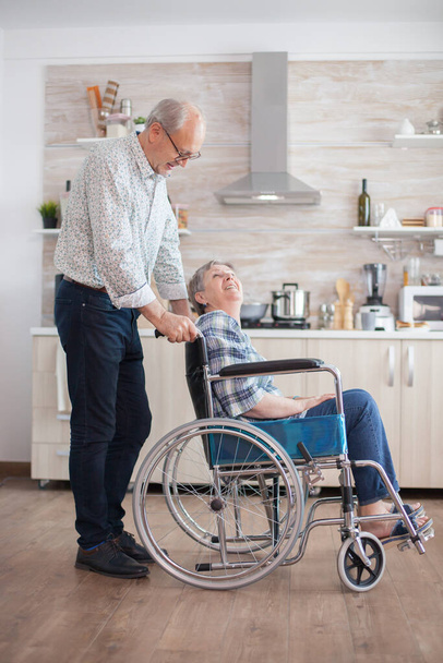 Husband looking at disabled senior woman - Foto, Imagen