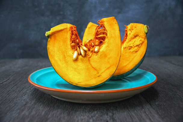 Sliced pumpkin on a plate - Фото, изображение