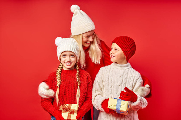 pretty woman and happy children celebrate Christmas together - Zdjęcie, obraz