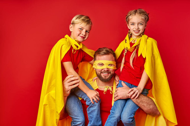 kind responsible father with children pretend to be superhero - Foto, imagen