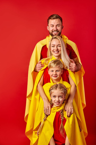 happy caucasian family pretending to be superhero in the park - Photo, image
