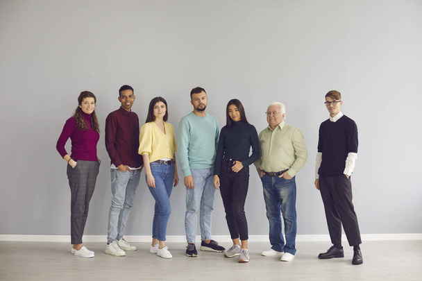 Group of diverse people in casual clothes standing together and looking at camera - Фото, изображение