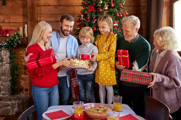 big family exchanging gifts for christmas - 写真・画像