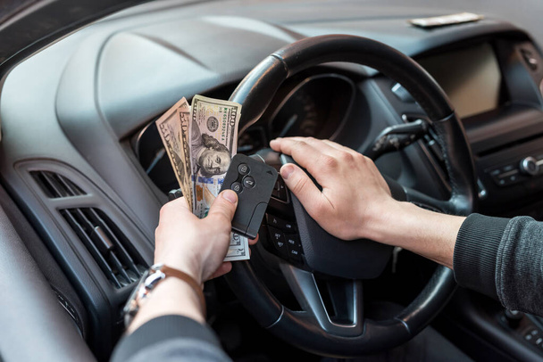 man hold dollar and car key for pay rent or bribe. finance - Valokuva, kuva