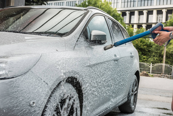 Car cleaning. Female wash hew car with foam. proffesional - Foto, immagini