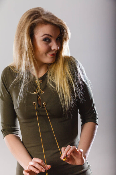 Fashionable outfit ideas, trendy clothes concept. Attractive blonde woman wearing tight dark green khaki top - Фото, зображення
