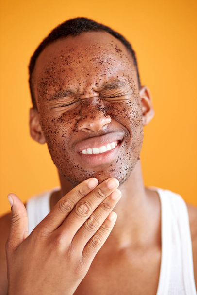 happy black male with mud healthy scrub on face - Foto, Imagem
