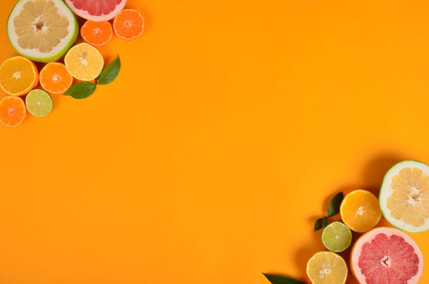 Corners placed and sliced cut citrus on a yellow background, Citrus background, copy space - Fotó, kép