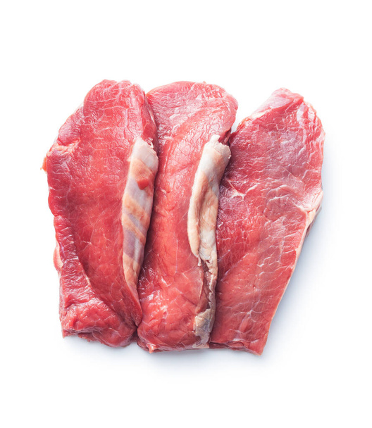 Slices raw striploin steak isolated on white background. Top view. - Foto, Bild