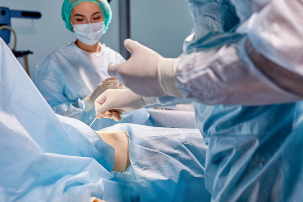 team of surgeons is fighting for life of sick patient - 写真・画像
